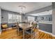 Dining room with hardwood floors, a modern light fixture, and shuttered windows at 2548 E Compton St, Orlando, FL 32806