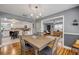Elegant dining room featuring hardwood floors and a modern chandelier, adjacent to the bright, open kitchen at 2548 E Compton St, Orlando, FL 32806
