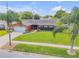 Inviting single-story home with a lush green lawn and mature palm trees at 2548 E Compton St, Orlando, FL 32806