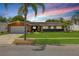 Charming single-story home with a well-manicured lawn and a colorful sunset backdrop at 2548 E Compton St, Orlando, FL 32806