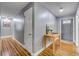 Hallway with hardwood floors and neutral paint leading to the front door at 2548 E Compton St, Orlando, FL 32806
