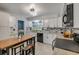 Beautiful kitchen with white cabinets, granite countertops, stainless appliances, island seating and tile flooring at 2548 E Compton St, Orlando, FL 32806