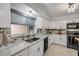 Bright kitchen featuring granite counters, stone backsplash, stainless steel appliances and ample cabinet space at 2548 E Compton St, Orlando, FL 32806