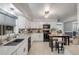 Modern kitchen with white cabinets, stone countertops, and stainless steel appliances at 2548 E Compton St, Orlando, FL 32806