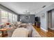 Comfortable living room featuring a plush sectional sofa, hardwood floors, and stylish decor at 2548 E Compton St, Orlando, FL 32806