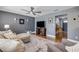 Cozy living room with a large sectional, ceiling fan, and a view into the entryway at 2548 E Compton St, Orlando, FL 32806