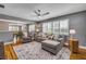 Relaxing living room with a large sectional sofa, ceiling fan, and a view into the dining room at 2548 E Compton St, Orlando, FL 32806