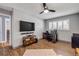 Well-lit office space with a desk and chair plus an entertainment area with TV at 2548 E Compton St, Orlando, FL 32806
