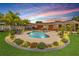 Beautiful backyard with a kidney-shaped pool, spa, and lush landscaping at dusk at 2548 E Compton St, Orlando, FL 32806