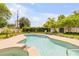 Inviting backyard with a sparkling pool, hot tub, lush landscaping, and comfortable seating for relaxation and entertainment at 2548 E Compton St, Orlando, FL 32806