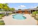 Inviting pool with hot tub, lounge chairs, surrounding patio and tropical landscaping at 2548 E Compton St, Orlando, FL 32806