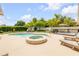 Private backyard oasis with sparkling pool, hot tub, lounge chairs and manicured landscaping at 2548 E Compton St, Orlando, FL 32806