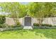Backyard storage shed surrounded by lush landscaping, offering a convenient and aesthetically pleasing storage solution at 2548 E Compton St, Orlando, FL 32806