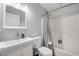 Clean bathroom featuring a shower with a gray curtain, white toilet and vanity at 2713 Needle Palm Dr, Edgewater, FL 32141