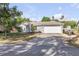 Charming single-story home with a well-maintained lawn and a two-car garage with a boat to the side at 2713 Needle Palm Dr, Edgewater, FL 32141