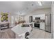 Bright kitchen with stainless steel appliances, white cabinets, and a functional island perfect for meal preparation at 2713 Needle Palm Dr, Edgewater, FL 32141