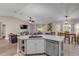 Open kitchen featuring a central island with stainless steel appliances and a seamless transition to the living area at 2713 Needle Palm Dr, Edgewater, FL 32141