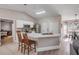 Bright open kitchen with white cabinets, stainless steel appliances, and an island with bar seating at 2713 Needle Palm Dr, Edgewater, FL 32141