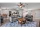 Open-concept living area with a sofa, dining table, and a view into the kitchen, blending living spaces at 2713 Needle Palm Dr, Edgewater, FL 32141