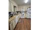 Functional kitchen with white appliances, wood cabinets, and ample countertop space for meal preparation at 2725 Travelers Palm Dr, Edgewater, FL 32141