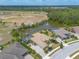 Stunning aerial view of a luxurious home with a pool, surrounded by a lush landscape and a serene lake at 2913 Linari Ct, New Smyrna Beach, FL 32168