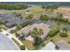 Gorgeous aerial view of home with screened pool, lush landscaping, pond, and golf course at 2913 Linari Ct, New Smyrna Beach, FL 32168