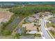 Panoramic aerial view showcasing beautiful homes with pools, nestled amidst lush greenery and a tranquil lake at 2913 Linari Ct, New Smyrna Beach, FL 32168