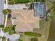 A high angle aerial view shows the roof and screened-in pool area of a house next to a lake at 2913 Linari Ct, New Smyrna Beach, FL 32168