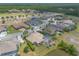Aerial view showcases luxury homes with pools, lush landscaping, and a golf course in the background at 2913 Linari Ct, New Smyrna Beach, FL 32168