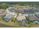 Aerial view of luxury homes on landscaped lots with screened pools, ponds and golf course in the background at 2913 Linari Ct, New Smyrna Beach, FL 32168