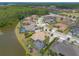 Beautiful aerial view of a neighborhood with waterfront properties and a golf course in the distance at 2913 Linari Ct, New Smyrna Beach, FL 32168