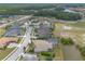 An aerial view displays well-kept homes with screened pools, beautiful landscaping, and a view of a golf course at 2913 Linari Ct, New Smyrna Beach, FL 32168