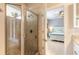 This bathroom features a walk-in shower with a glass door and a view to a Primary bedroom at 2913 Linari Ct, New Smyrna Beach, FL 32168