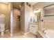 Bathroom features a tiled walk-in shower with built-in shelves, a vanity, a tub, and a toilet at 2913 Linari Ct, New Smyrna Beach, FL 32168