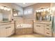 Bathroom has double vanities with granite counters, a soaking tub, and a large window at 2913 Linari Ct, New Smyrna Beach, FL 32168