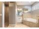 A spacious bathroom features a soaking tub, walk-in shower, and a vanity with light fixtures at 2913 Linari Ct, New Smyrna Beach, FL 32168