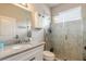 Bright bathroom features a glass-enclosed shower and granite countertop at 2913 Linari Ct, New Smyrna Beach, FL 32168