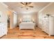 Serene bedroom with light wood floors, neutral colors, and barn door entry to the walk-in closet at 2913 Linari Ct, New Smyrna Beach, FL 32168