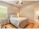 Well-lit bedroom with a large window, wood floors, and a modern design at 2913 Linari Ct, New Smyrna Beach, FL 32168