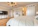 Light-filled bedroom featuring hardwood floors, a ceiling fan, and a sliding barn door to the closet at 2913 Linari Ct, New Smyrna Beach, FL 32168