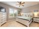 Bedroom features a queen size bed, two nightstands, a dresser, and tile floors at 2913 Linari Ct, New Smyrna Beach, FL 32168