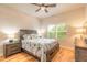 Cozy bedroom featuring a large window, hardwood floors, and a ceiling fan at 2913 Linari Ct, New Smyrna Beach, FL 32168