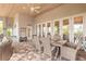 Comfortable covered patio with a dining table, seating area, and access to the outdoors through glass doors at 2913 Linari Ct, New Smyrna Beach, FL 32168