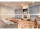Relaxing covered patio with a fireplace, comfortable seating, and ample space for entertaining guests at 2913 Linari Ct, New Smyrna Beach, FL 32168