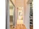Hallway view showcasing walk-in closet and bathroom with tiled floors and white vanity at 2913 Linari Ct, New Smyrna Beach, FL 32168