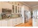 Stylish kitchen with white cabinets, granite counters, stainless appliances, and hardwood flooring at 2913 Linari Ct, New Smyrna Beach, FL 32168