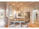 Open kitchen with granite countertop island, stainless appliances, white cabinetry, and barstool seating at 2913 Linari Ct, New Smyrna Beach, FL 32168