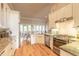Bright kitchen features stainless appliances, granite countertops, wood floors, and an open layout at 2913 Linari Ct, New Smyrna Beach, FL 32168