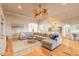 Inviting living room with open floor plan, large sectional, and view into the bright kitchen at 2913 Linari Ct, New Smyrna Beach, FL 32168