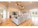 Spacious living room featuring hardwood floors, a large sectional, and a decorative entertainment center at 2913 Linari Ct, New Smyrna Beach, FL 32168